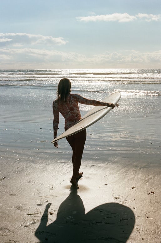 Woman with Surfboard at the Beach